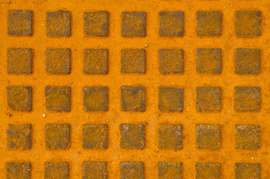 Great rusty iron metal sewer lid background. Yellow rusty steel details.