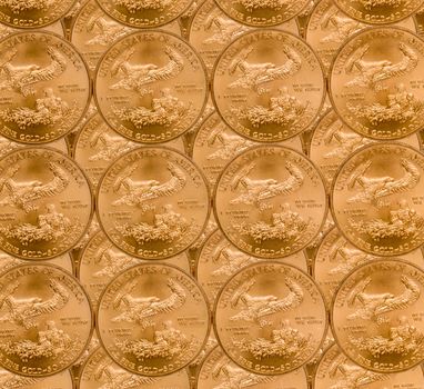 Gold Eagle one ounce coins in a patterns and stacked on each row