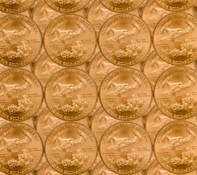 Gold Eagle one ounce coins in a patterns and stacked on each row