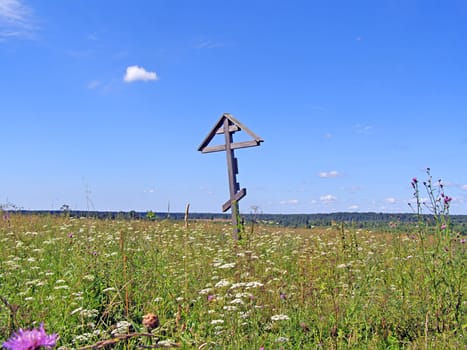 solitary cross on yellow autumn field