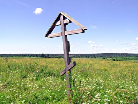 solitary cross on yellow autumn field