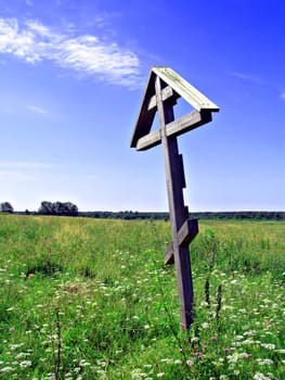 solitary cross on yellow autumn field