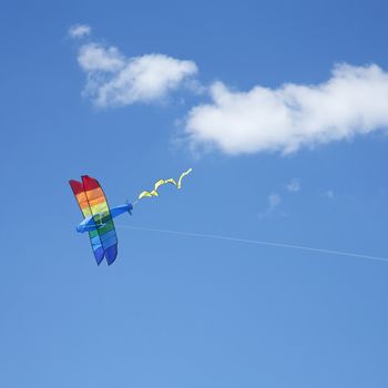 Plane kite Flying in the sky with white clouds 