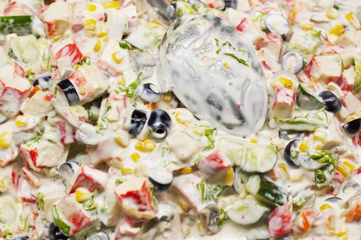 mixed salad with white dressing, with big spoon, suitable for background