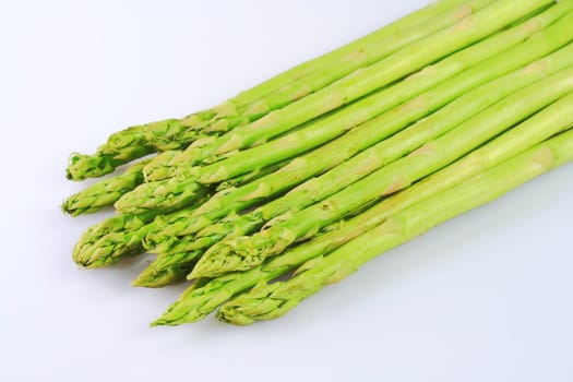 bunch of asparagus spears isolated in white background
