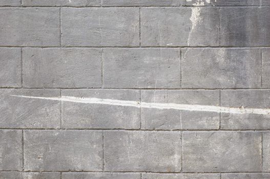 grunge background: dirty gray concrete bricks wall with scratches