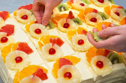 decorating the custard filled cakes with fruits