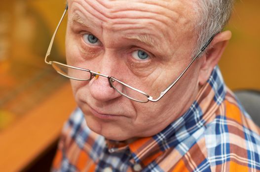 Casual senior man with glasses. Emotional portrait series.