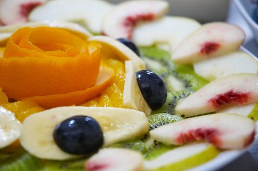 Perfectly designed fresh juicy fruit salad on plate.
Close-up series. Shallow DOF.