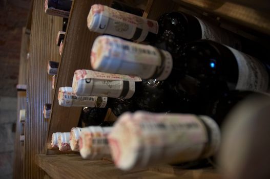 wine bottles laying in wooden rack