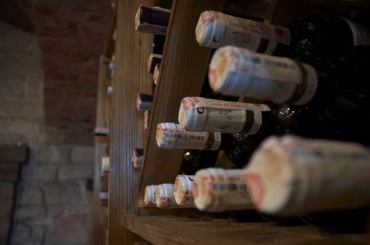 wine bottles laying in wooden rack