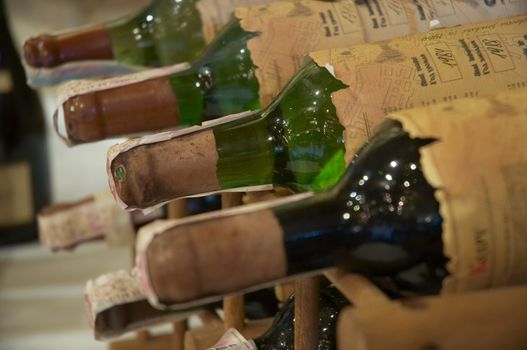 wine bottles laying in wooden rack