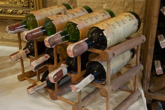 wine bottles laying in wooden rack