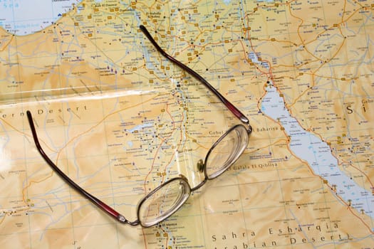 Glasses laying on a map, before a trip to travel