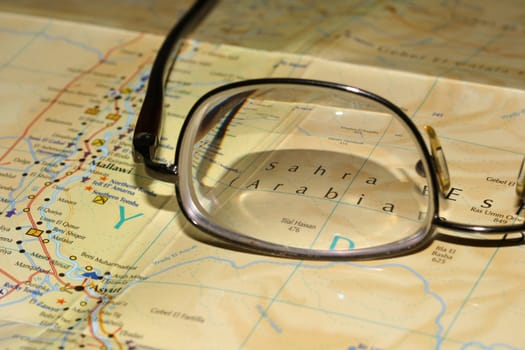 Glasses laying on a map, before a trip to travel