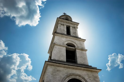 sun behind the bell tower. this is not a collage.