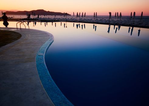 Windstill on greek pool in the sunset