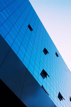 business building with some opened windows on mirror fasade 