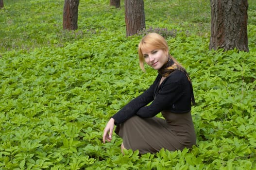 Blond beautiful girl in the spring forest.