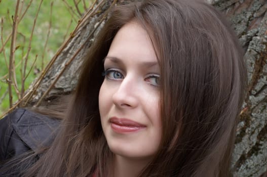 outdoor portrait of the pretty brunette with blue eyes