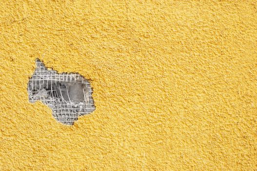 yellow rough stucco, deeply punched. material texture.