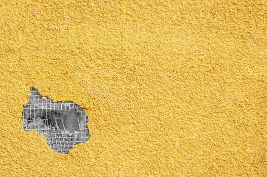 yellow rough stucco, deeply punched. material texture.