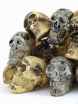 A pile of plastic toy skulls studio isolated over a white background.