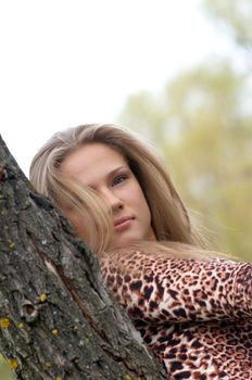 Girl staying near the tree. Lot of copyspace.