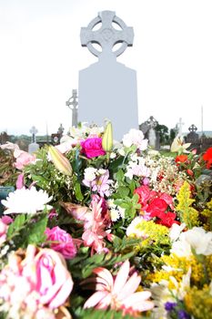 an old graveyard in the irsh midlands with flowers on a grave