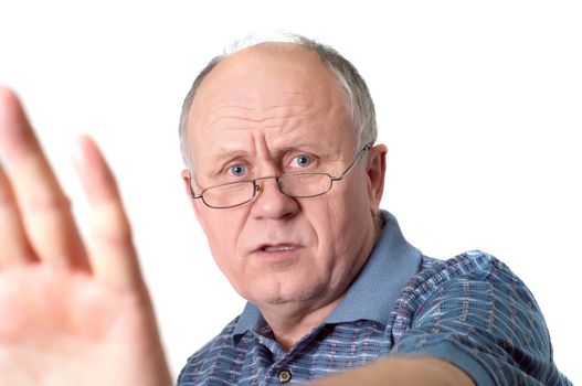 Bald senior man's gesture "talk to the hand". Isolated on white.