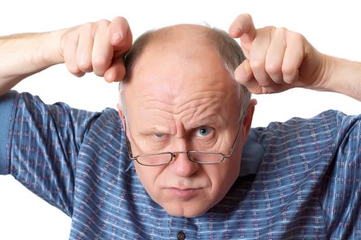 Bald senior man fooling around. Isolated on white. Emotional portraits series.