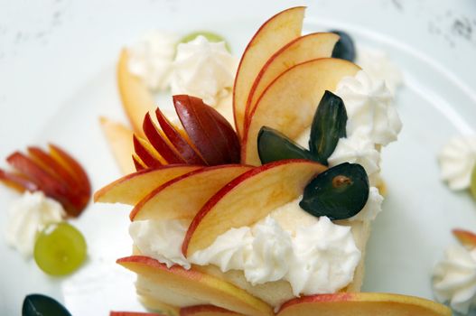 layered cake decorated with fruits and cream