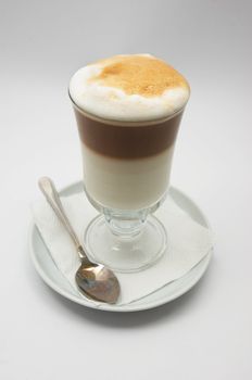 just brewed glass mug of coffee frappe with crisp foam.