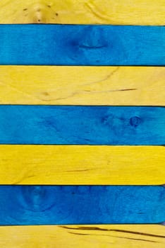 horizontal arrangement of blue and yellow wood in portrait orientation