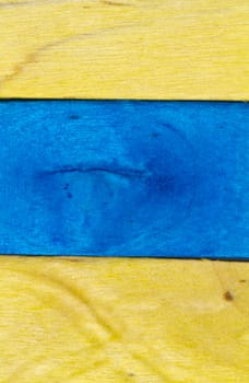 horizontal arrangement of blue and yellow wood in portrait orientation