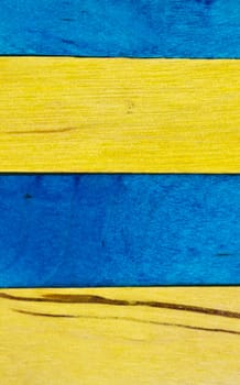 horizontal arrangement of blue and yellow wood in portrait orientation