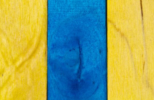 Vertical arrangement of blue and yellow wood in landscape orientation