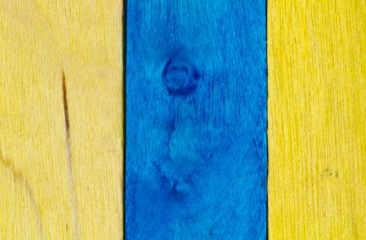 Vertical arrangement of blue and yellow wood in landscape orientation