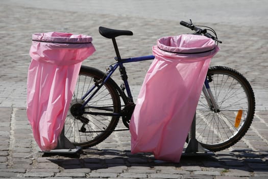 Pink litterbags and parked bike in the La Villette area - Paris, France.