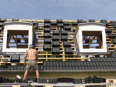 Man working with rebuilding an old urban house.