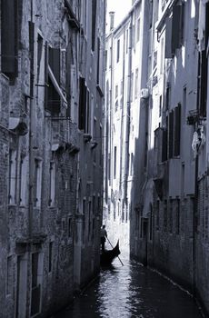 Gondola in narrow canal - Urban Venice.