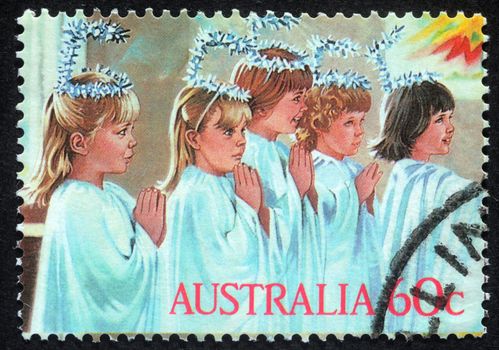 AUSTRALIA - CIRCA 2004: A greeting Christmas stamp printed in Australia shows children play to the Holy Family