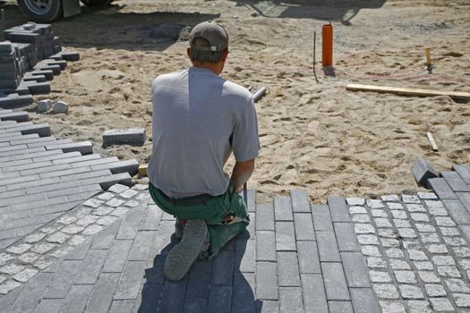 Paver on job. Constructing a difficult pattern.
