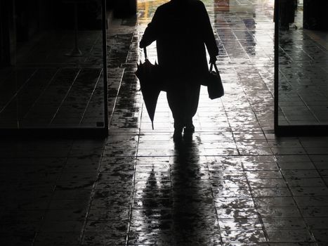 Woman in the doorway of a shopping center.