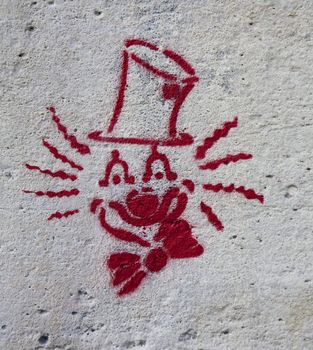 Face of a clown - stencil graffiti on Parisian wall.