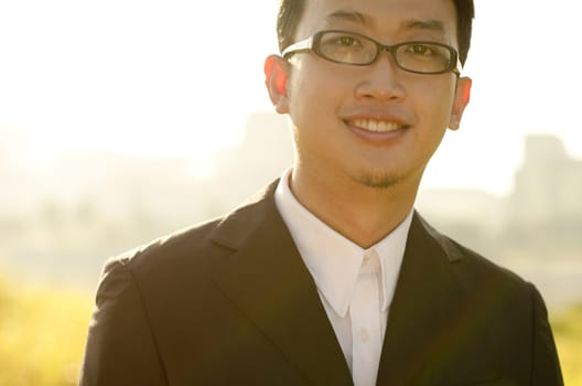 Asian groom at outdoor in a morning surrounding by golden sunlight