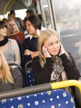 Woman listen to music while going by the bus