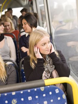 Woman listen to music while going by the bus