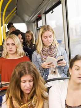 Woman on the bus reading a book