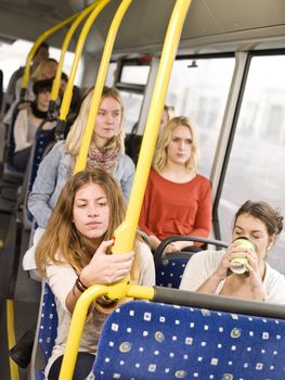 Woman pressing the stop botton on the bus